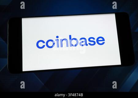 Coinbase logo displayed on a smartphone screen. Coinbase is a cryptocurrency exchange and digital asset company Stock Photo