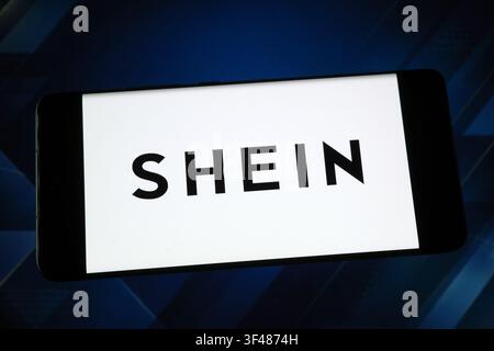 SHEIN logo displayed on a smartphone screen. SHEIN is a global fast fashion e-commerce retailer Stock Photo