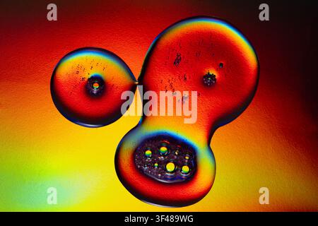 Abstract image featuring vibrant neon drops and cosmetic bubbles in a spectrum of colors. The vivid hues blend seamlessly, creating an eye-catching vi Stock Photo