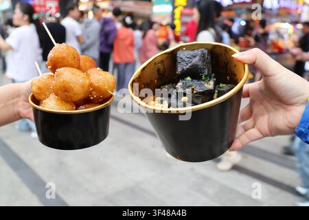 A bowl of stinky tofu and sugar-oil-cake (Tang You Baba) are traditional famous snacks of Changsha City, Hunan Province of China Stock Photo