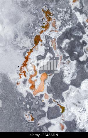 Aerial abstract view of saline surface patterns and mineral textures on Antofalla Salt Flat in Catamarca, Argentina, featuring gray salt crust and rus Stock Photo