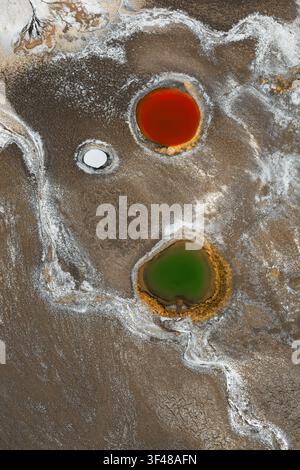 Aerial abstract view of saline surface patterns and colorful brine pools on Antofalla Salt Flat in Catamarca, Argentina, showcasing striking natural t Stock Photo