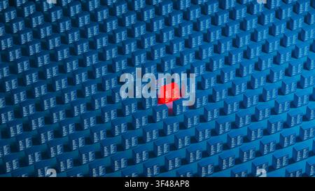 A red technology server cube stands out among many blue cubes. Each cube is marked with code and forms a vast network, showing data. Stock Photo