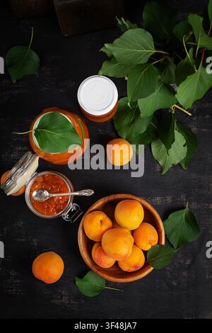 Homemade Apricot Marmalade in Jars on Dark Background. Top view Stock Photo