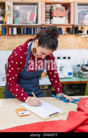 Woman working in tailoring workshop sketching design Stock Photo