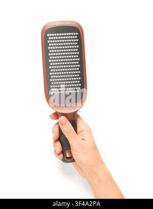 Person holding a brown and black foot file for pedicure and dead skin removal, isolated on a clean white background Stock Photo