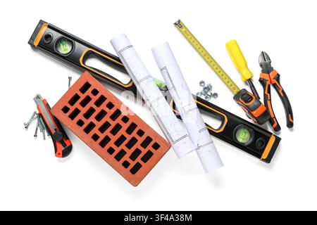 Set of construction workers tools with house plans and brick on white background Stock Photo
