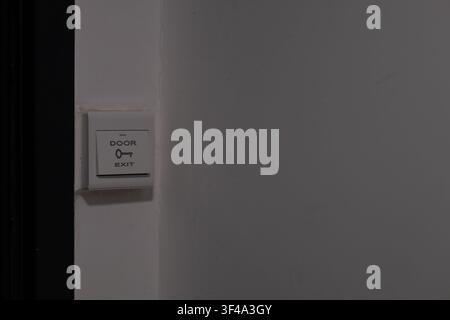 Door exit switch mounted on wall with copy space for access control concept Stock Photo