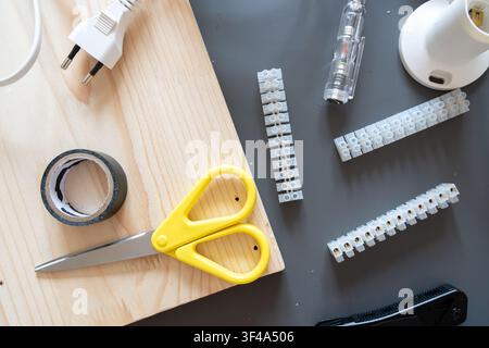 Close-up of tools and electrical components for a DIY light fixture project Stock Photo