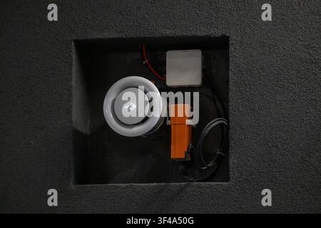 Electronic control equipment installed inside recessed wall compartment in modern building Stock Photo