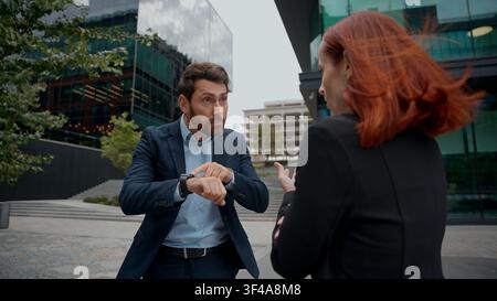 Angry stressed business man woman conflict quarrel deal problem arguing in city negative conversation misunderstanding communicate corporate trouble Stock Photo