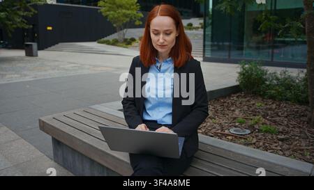 Caucasian business woman employer talking video call online laptop in city bench manager internet lesson businesswoman entrepreneur consulting client Stock Photo