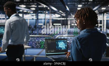 Data center coworkers doing maintenance on mainframes handling AI processing tasks. Server hub system administrators managing storage arrays supporting deep learning training workflows, Stock Photo