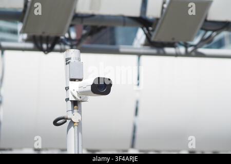 CCTV camera monitors activity in urban area Stock Photo
