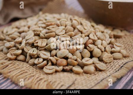 Coffee beans on burlap in a market setting Stock Photo