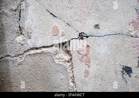 Cracked wall with peeling paint in an old building Stock Photo