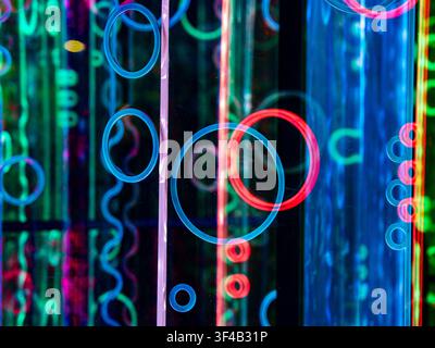 Neon light rings and swirling lines overlapping in vivid abstract artwork Stock Photo