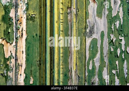 Deteriorating peeling cracked paint on a wooden door Stock Photo