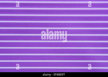 Abstract purple textured background featuring horizontal white parallel lines and ribbed surface Stock Photo