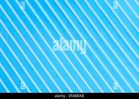 Bright blue textured surface with diagonal parallel white lines creating vibrant modern background Stock Photo