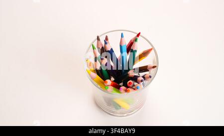 Colored sharpened wooden pencils in various colors in a glass jar Stock Photo