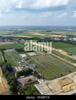 Aerial view of the Neufinsing electrical substation surrounded by green agricultural fields and power lines in Finsing, Bayern, Germany. Stock Photo
