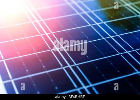 Solar panel surface background close-up. Solar technology concept. Detailed macro shot of a modern blue photovoltaic solar panel surface, highlighting the grid pattern, semiconductor cells, and technology used for clean and renewable energy generation. Stock Photo