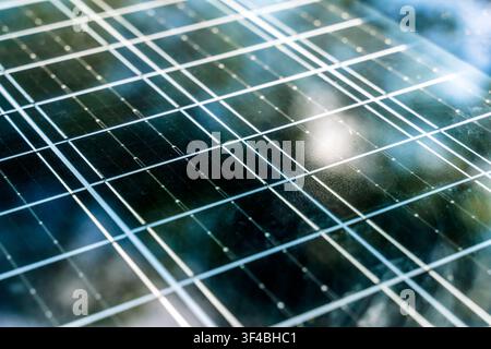 Solar panel surface background close-up. Solar technology concept. Detailed macro shot of a modern blue photovoltaic solar panel surface, highlighting the grid pattern, semiconductor cells, and technology used for clean and renewable energy generation. Stock Photo