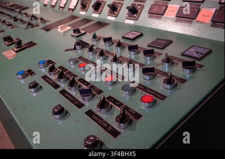 Detail of vintage industrial control panel with switches, knobs, and indicator lights in Catalonia, Spain. Stock Photo
