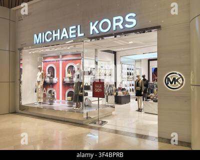 Kuala Lumpur, Malaysia - July 7, 2025: storefront of MICHAEL KORS featuring mannequins in fashionable attire and a visible SALE 50% sign in the window Stock Photo