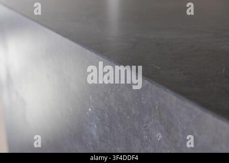 This image showcases a detailed view of a contemporary stone countertop with a polished surface Stock Photo
