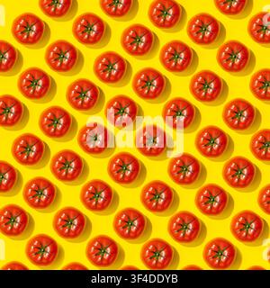 Whole red tomatoes arranged in dense pattern on bright yellow background Stock Photo