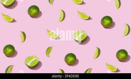 Whole limes and citrus slices scattered in pattern on pink background Stock Photo