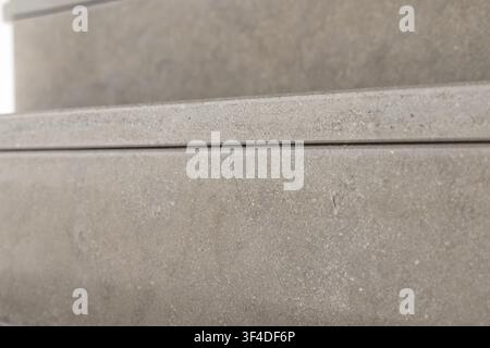 Detailed view of rough concrete surfaces stacked, showing granular texture and a fine dividing line between layers Stock Photo