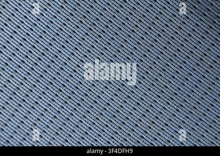 A light blue fabric texture pattern knit textile closeup soft woven surface with diagonal ribbed stitches creating subtle shadow and depth, calm tacti Stock Photo