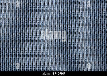 A light blue knitted textile pattern with vertical ribbing and small holes, soft textured fabric evoking cozy comfort and subtle rhythm Stock Photo