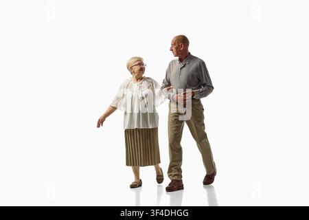 Senior couple discussing directions while walking isolated on white background Stock Photo