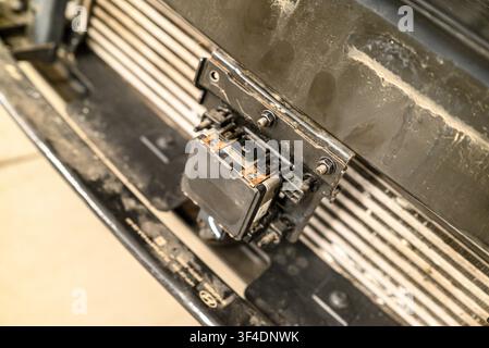 Automotive technology showing a smart cruise control sensor attached to a metal bracket Stock Photo