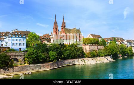 Beautiful Landscape of Basel Old Town, with the cathedral and steeples rising in the background against a bright blue summer sky. Stock Photo