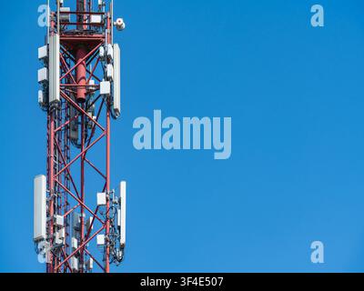 Mobile Telecommunications Tower for 5G Wireless Network Against Bright Blue Sky Stock Photo
