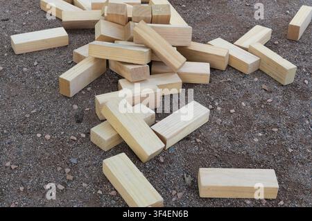 Wooden blocks stacked in a pile on the ground, closeup of photo Stock Photo