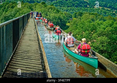 Canoeists following a barge flotilla across the Pontcysyllte Aqueduct which carries the Llangollen arm of the Shropshire Union Canal in North Wales. Stock Photo