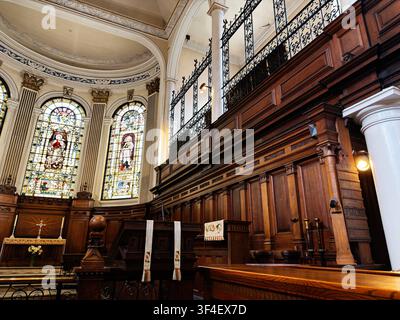 Manchester, UK - May 10, 2026: Elegant Manchester, UK St Ann's church interior with stained glass windows, wooden chancel, pulpit and ornate architect Stock Photo