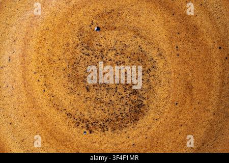 Freshly brewed espresso crema surface with golden frothy micro bubbles Stock Photo