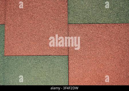close up shot of a red textured rubber flooring with diagonal geometric seams Stock Photo
