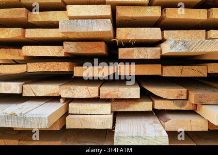 Stacked wooden planks texture. Freshly harvested wooden planks for construction and manufacturing Stock Photo
