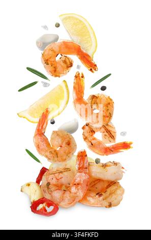 Tasty grilled shrimps, lemon slices, garlic cloves, rosemary and peppercorns falling on white background Stock Photo