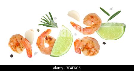 Tasty grilled shrimps, lime slices, garlic cloves, rosemary and peppercorns falling on white background Stock Photo