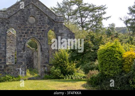 Abandoned Roofless Church Ruins Overgrown with Vegetation Stock Photo