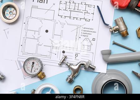 Composition with plumbers items and house plans on blue background Stock Photo